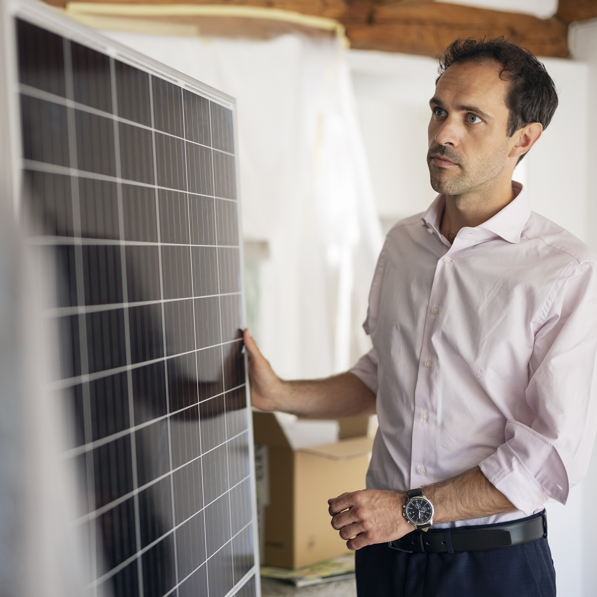Mann hält Solarmodul